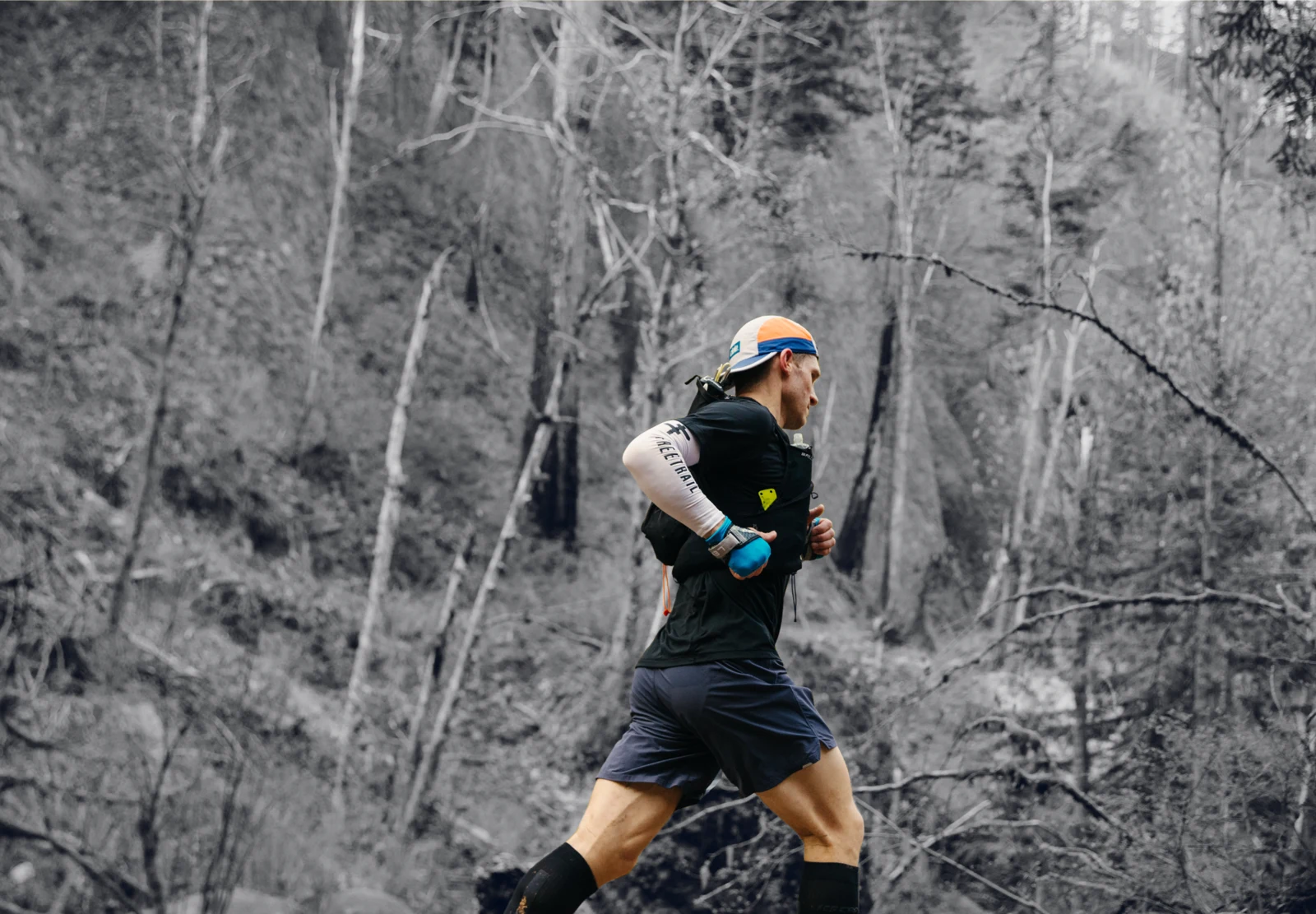 A runner moving along a wooded trail