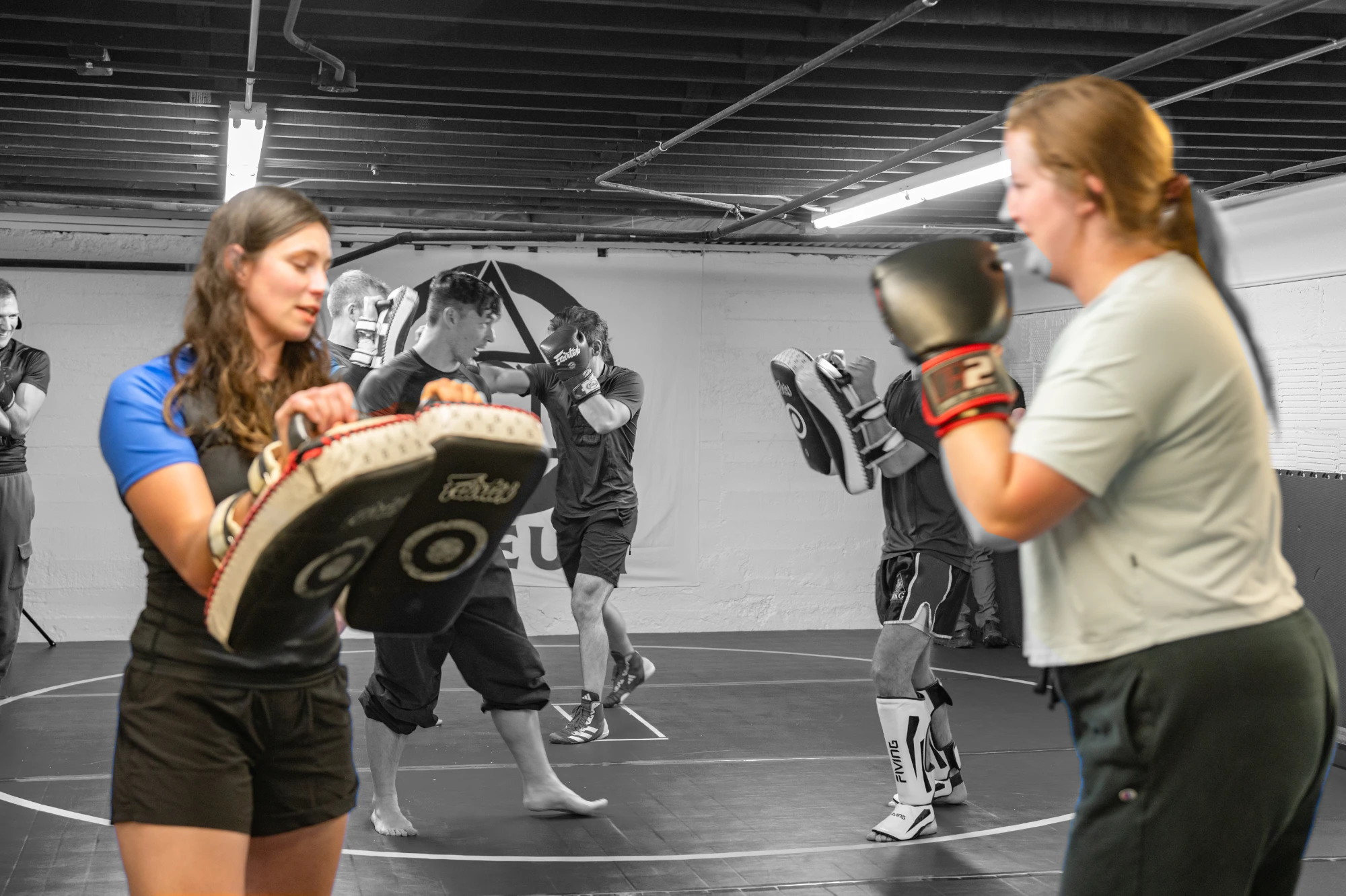 Partners practicing striking with pads